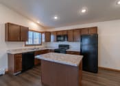 Thumbnail 25 of 42 - a kitchen with black appliances and white countertops. Fargo, ND Westwood Apartments