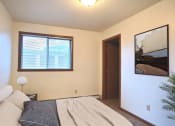 Thumbnail 5 of 42 - a bedroom with a bed and a window. Fargo, ND Westwood Estates Apartments