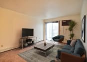 Thumbnail 3 of 42 - a living room with a couch coffee table and tv. Fargo, ND Westwood Estates Apartments