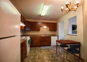Thumbnail 2 of 42 - a kitchen with white appliances and wooden cabinets. Fargo, ND Westwood Estates Apartments