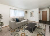 Thumbnail 2 of 13 - a living room with a couch and a coffee table. Fargo, ND White Ridge Apartments