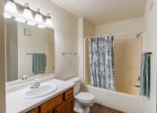 Thumbnail 12 of 24 - a bathroom with a sink and a toilet and a shower. Fargo, ND Willow Park Apartments