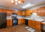 Thumbnail 8 of 24 - a kitchen with black appliances and white countertops. Fargo, ND Willow Park Apartments