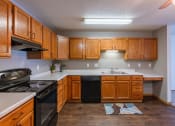 Thumbnail 9 of 24 - a kitchen with black appliances and white countertops. Fargo, ND Willow Park Apartments