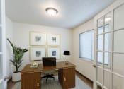 Thumbnail 5 of 24 - a den with a desk and window with French doors. Fargo, ND Willow Park Apartments