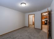 Thumbnail 21 of 24 - a bedroom with a walk in closet and bathroom. Fargo, ND Willow Park Apartments