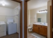 Thumbnail 23 of 24 - a bathroom and laundry room. Fargo, ND Willow Park Apartments