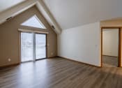 Thumbnail 18 of 24 - a living room with vaulted ceilings and large windows. Fargo, ND Willow Park Apartments