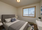 Thumbnail 5 of 9 - Fargo, ND Windgate Apartments. a bedroom with a large bed and a large window the brightens the room