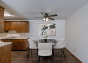 Thumbnail 3 of 15 - a dining room with a table and chairs and a ceiling fan. Fargo, ND Windsor Apartments