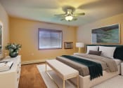 Thumbnail 5 of 21 - a bedroom with a bed and a ceiling fan. Fargo, ND Wolf Creek Apartments