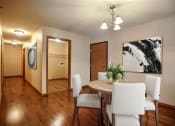 Thumbnail 3 of 21 - a dining room with a wooden table and white chairs. Fargo, ND Wolf Creek Apartments