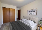 Thumbnail 3 of 17 - a bedroom with a bed and a closet. Fargo, ND Woodland Apartments