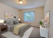 Thumbnail 4 of 17 - a bedroom with a bed and a window. Fargo, ND Woodland Apartments