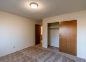 Thumbnail 13 of 17 - a bedroom with a door to a closet. Fargo, ND Woodland Apartments