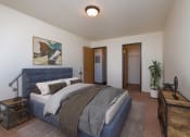 Thumbnail 7 of 11 - a bedroom with a bed and a dresser and a closet. Moorhead, MN Woodstone Apartments