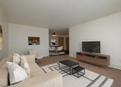 Thumbnail 3 of 11 - a living room with a couch and a coffee table. Moorhead, MN Woodstone Apartments