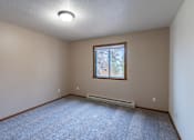 Thumbnail 21 of 26 - a bedroom with a window and carpet. Fargo, ND Briar Pointe Apartments
