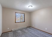 Thumbnail 19 of 26 - a bedroom with carpet and a window.Fargo, ND Briar Pointe Apartments