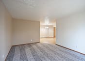 Thumbnail 15 of 26 - the living room and dining room of an apartment with carpeting and white walls. Fargo, ND Briar Pointe Apartments