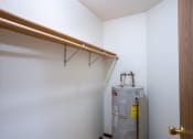 Thumbnail 23 of 33 - a room with a water heater and a pipe on the wall and a closet. Fargo, ND Brownstone Apartments