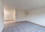 Thumbnail 12 of 33 - the living room and dining room of an apartment with carpet and white walls. Fargo, ND Brownstone Apartments