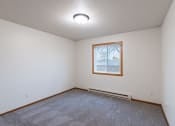 Thumbnail 30 of 33 - a bedroom with a window. Fargo, ND Brownstone Apartments