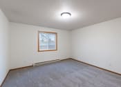 Thumbnail 28 of 33 - a bedroom with carpet and a window. Fargo, ND Brownstone Apartments