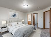 Thumbnail 3 of 33 - a bedroom with a bed and a closet. Fargo, ND Brownstone Apartments
