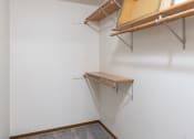 Thumbnail 31 of 33 - a walk in closet with shelves and a window. Fargo, ND Brownstone Apartments