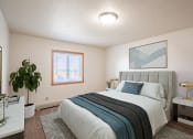 Thumbnail 2 of 41 - an empty bedroom with a bed and a plant. Fargo, ND Carlton Place Apartments