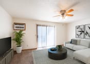 Thumbnail 1 of 41 - a living room with a couch and a coffee table and a ceiling fan. Fargo, ND Carlton Place Apartments