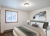 Thumbnail 4 of 15 - a bedroom with a bed and a window. Fargo, ND Cedar Pointe Apartments