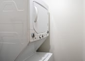 Thumbnail 12 of 15 - a washer and dryer in a small laundry room. Fargo, ND Cedar Pointe Apartments