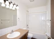 Thumbnail 13 of 42 - a bathroom with a sink and a shower and a toilet. Fargo, ND Country Club Apartments