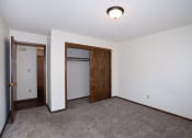 Thumbnail 15 of 42 - an empty room with carpet and a door to a closet