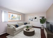 Thumbnail 1 of 42 - a living room with a white couch and a round coffee table.  Fargo, ND Country Club Apartments
