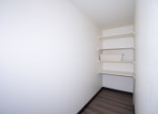 Thumbnail 40 of 42 - a room with white walls and shelves and a wooden floor. Fargo, ND Country Club Apartments