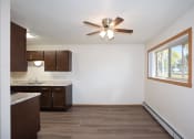 Thumbnail 33 of 42 - an empty kitchen with a ceiling fan and a window. Fargo, ND Country Club Apartments