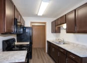 Thumbnail 32 of 42 - aa kitchen with black appliances. Fargo, ND Country Club Apartments