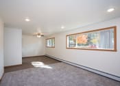 Thumbnail 30 of 42 - a living room with a large window and a carpet. Fargo, ND Country Club Apartments