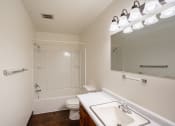 Thumbnail 11 of 18 - a bathroom with a sink and a toilet and a shower. Fargo, ND Crown Court 1 Apartments