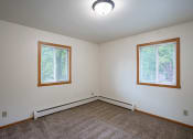 Thumbnail 16 of 18 - a bedroom with two windows. Fargo, ND Crown Court 1 Apartments
