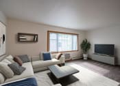 Thumbnail 1 of 18 - a living room with a couch and a tv. Fargo, ND Crown Court 1 Apartments