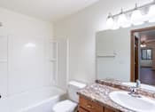 Thumbnail 19 of 23 - a bathroom with a sink and a toilet and a bath tub. Fargo, ND Flagstone Apartments