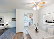 Thumbnail 2 of 23 - our living room and dining room with a white table and chairs and a ceiling fan. Fargo, ND Flagstone Apartments