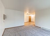 Thumbnail 12 of 23 - the living room and dining room of an apartment with white walls and wood flooring. Fargo, ND Flagstone Apartments