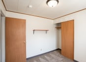 Thumbnail 5 of 7 - an empty room with a door to a closet. Fargo, ND Forest Avenue Apartments