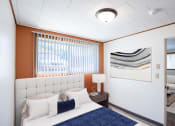 Thumbnail 2 of 7 - a bedroom with a bed and a painting on the wall. Fargo, ND Forest Avenue Apartments