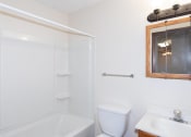 Thumbnail 11 of 13 - a small bathroom with a toilet sink and shower. Fargo, ND Hartford Apartments
